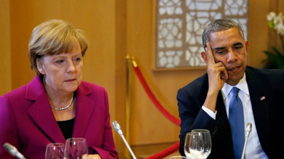 U.S. President Barack Obama and German Chancellor Angela Merkel listen during the G7 Summit working dinner in Brussels