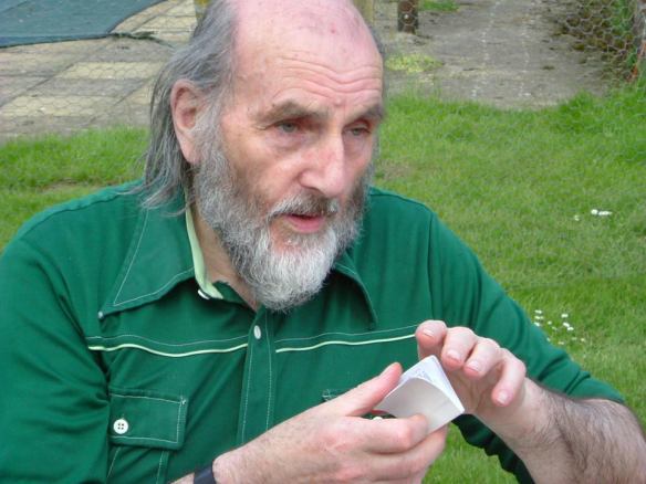 John Peck holding a tiny Bible